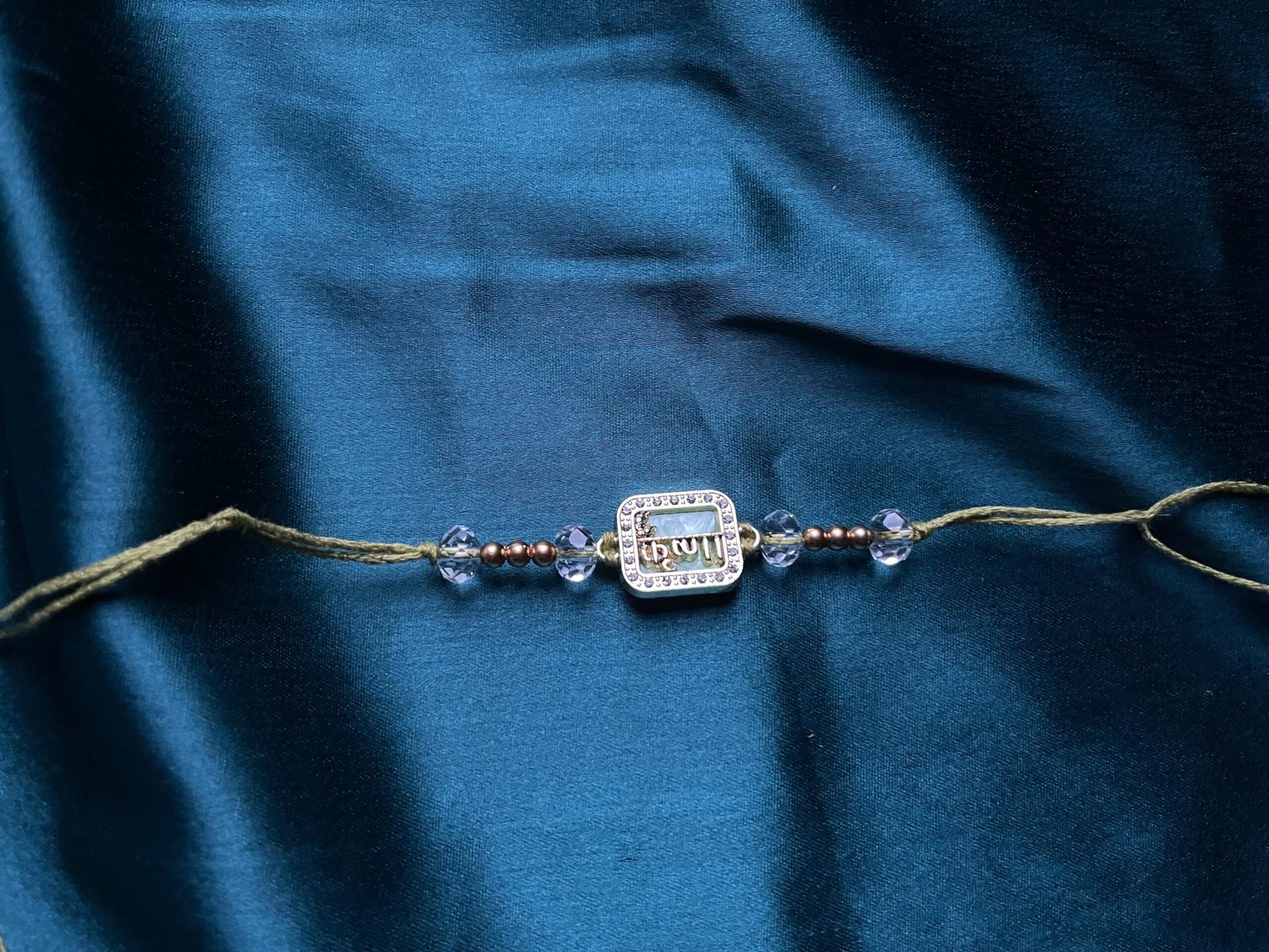 Elegant Crystal-Beaded Rakhi Bracelet - Gold-Plated with Om Motif